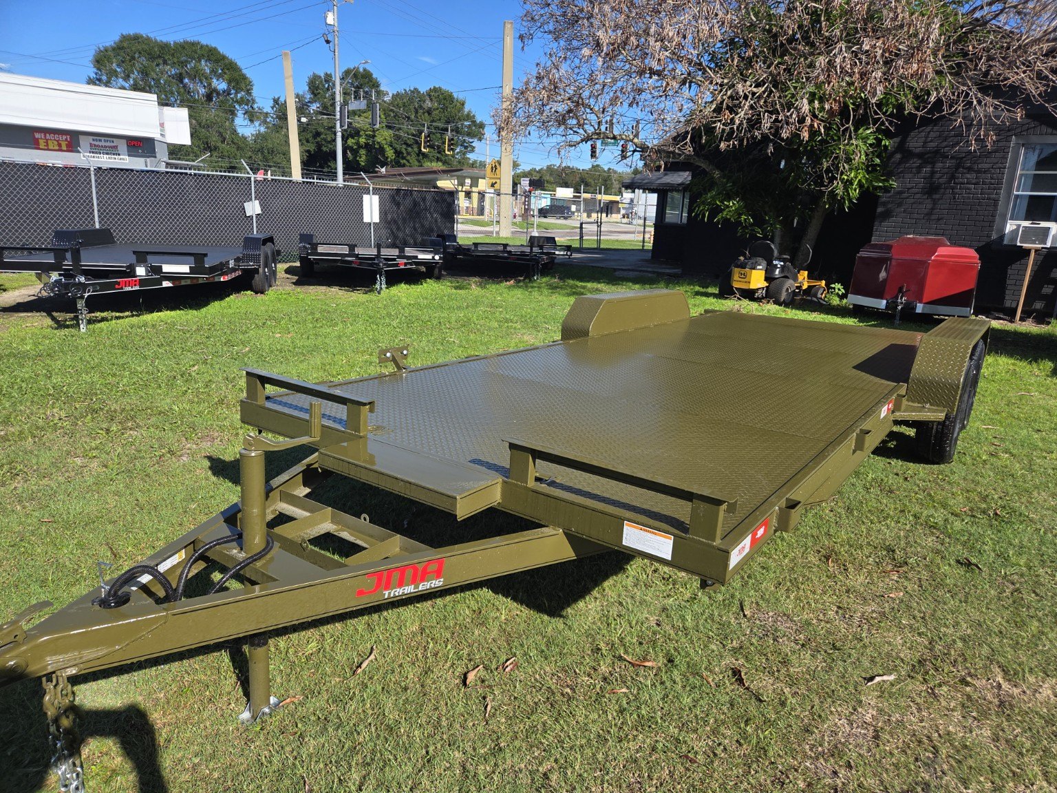 Olive green steel deck trailer, front view